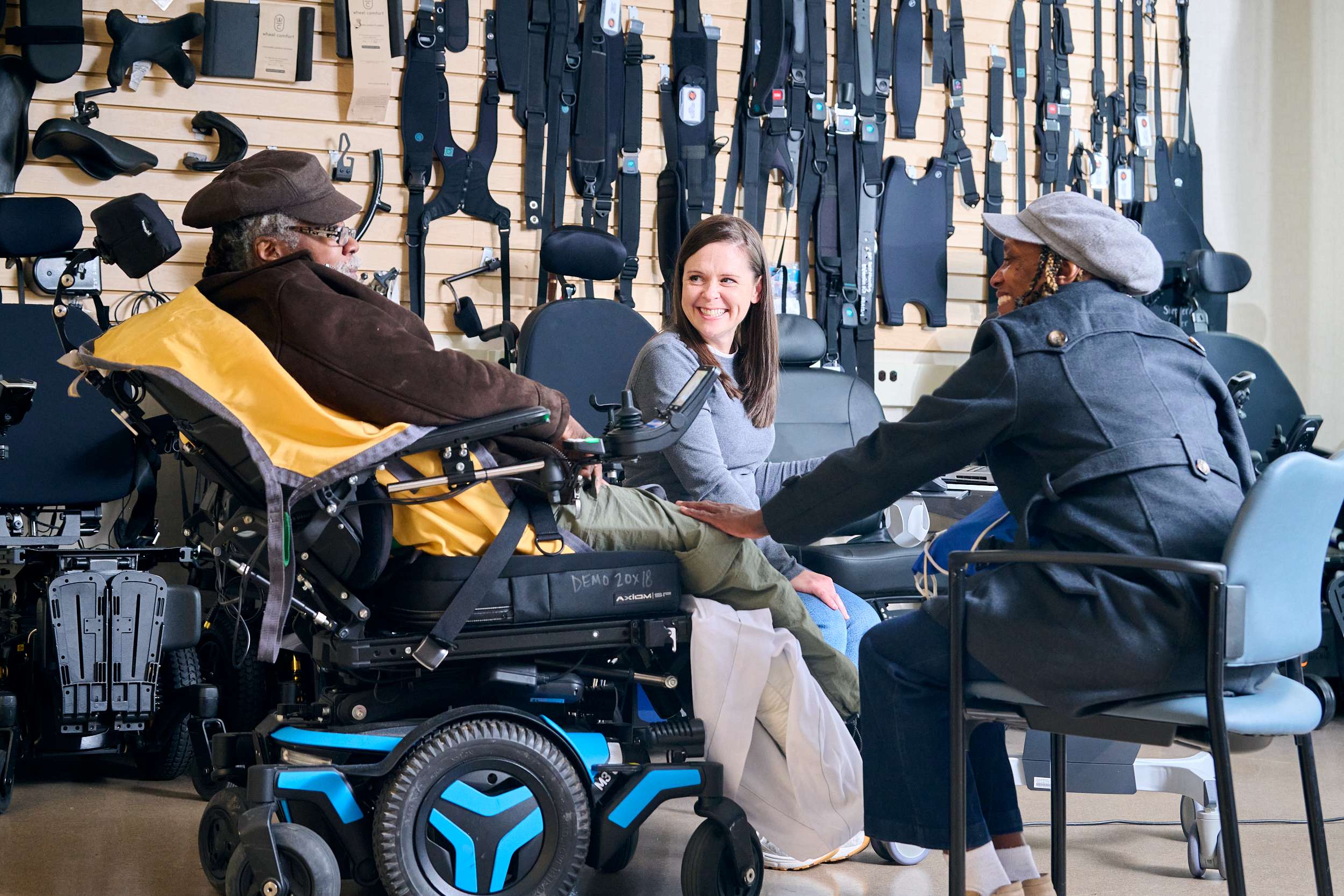 Male patient receives a moment of support from his companion during his wheelchair seating evaluation with their Occupational Therapist in the Wheelchair Seating and Mobility Clinic.
